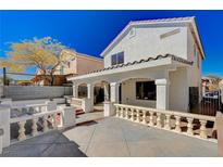 Inviting backyard patio featuring covered area with detailed columns and a charming decorative railing at 4839 Englewood Ave, Las Vegas, NV 89139