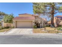 Charming home featuring a tile roof, two car garage and desert landscaping at 4925 Turtle Point Dr, Las Vegas, NV 89113