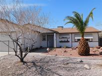 Charming single-story home featuring a desert landscape and a decorative pineapple palm tree in the front yard at 710 Strawberry Pl, Henderson, NV 89002