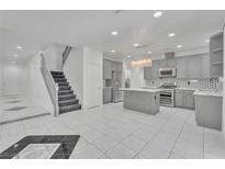 Open concept kitchen with grey cabinets, stainless steel appliances, and a beautiful island at 7917 Sally Irene Ct, Las Vegas, NV 89113