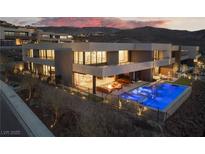 Stunning exterior view of a modern home with a pool and outdoor living area, perfect for entertaining and relaxing at 801 Dragons Eye Dr, Henderson, NV 89012