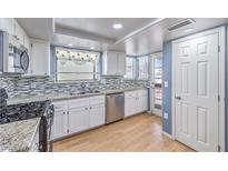 Traditional-style kitchen featuring stainless steel appliances and beautiful granite countertops at 8229 Willeta Ave, Las Vegas, NV 89145