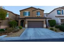 Two-story home featuring a two-car garage, arched entryway, neutral stucco, and well-maintained landscaping at 10139 Palazzo Marcelli Ct, Las Vegas, NV 89147