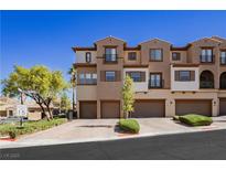 View of a three-story townhome with tan stucco, brown trim, and a brick driveway on a sunny day at 1092 Via Corto St, Henderson, NV 89011