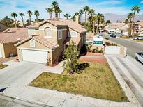 Charming two-story home featuring a well-manicured lawn, RV parking, and desert landscaping at 1508 Splinter Rock Way, North Las Vegas, NV 89031