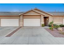 Charming single-story home with a two-car garage, landscaped yard, and desert rock at 209 Roxborough St, Henderson, NV 89074