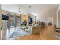 Bright living room features hardwood floors, balcony access, and an open floor plan at 2325 Windmill Pkwy # 323, Henderson, NV 89074