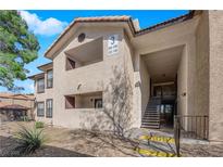 A two story condominium building featuring stairwell access and covered balconies at 2451 N Rainbow Blvd # 1006, Las Vegas, NV 89108