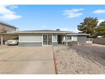 Single-story home featuring a large front yard, driveway, and a covered carport at 4272 E Russell Rd, Las Vegas, NV 89120