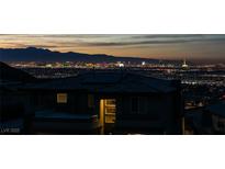 Striking cityscape view from property with a house silhouette and solar panels visible at 522 Riley Ridge Ct, Henderson, NV 89012