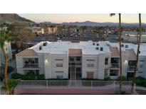 A charming apartment building with a stucco exterior and tile roof accents at 6800 E Lake Mead Blvd # 1126, Las Vegas, NV 89156