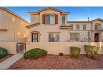 Charming two-story townhome features desert landscaping, a private front yard, and a classic stucco facade at 9564 Belle Fountain Ave, Las Vegas, NV 89123