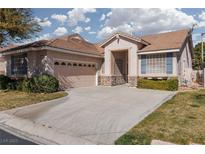 Charming single-story home featuring a two-car garage, manicured lawn, and inviting curb appeal at 10300 Pinto Creek Ln, Las Vegas, NV 89144