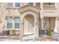 Charming condo featuring a stucco facade, arched entryway, and well-maintained landscaping at 10550 W Alexander Rd # 2057, Las Vegas, NV 89129