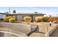 Charming single-story home with a desert landscape, solar panels, and a welcoming walkway at 19 Montana Way, Henderson, NV 89015