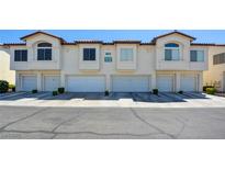 Inviting townhouse complex featuring multiple garage units and well-maintained landscaping at 4810 Black Bear Rd # 204, Las Vegas, NV 89149