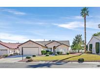 Charming single-story home with a well-manicured front lawn and desert landscaping at 5005 Cliffrose Dr, Las Vegas, NV 89130