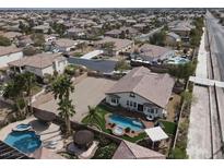 Expansive home with a refreshing pool, spa, palapas, and a spacious area for parking or recreation at 6392 Ebony Legends Ave, Las Vegas, NV 89131