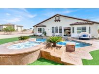 Inviting backyard features a sparkling pool, spa, and ample seating for relaxing and entertaining at 6392 Ebony Legends Ave, Las Vegas, NV 89131