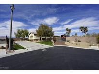 Charming single-story home featuring a well-manicured front yard, gated driveway, and desert landscaping at 6392 Ebony Legends Ave, Las Vegas, NV 89131