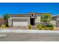 Charming single story home featuring neutral stucco, stone accents, brick driveway and a two car garage at 8525 Stokestone St, Las Vegas, NV 89166