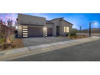 Modern home featuring a three-car garage and neatly landscaped front yard at 10065 Auburn Rose Ave, Las Vegas, NV 89143