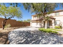 Charming two-story home with well-maintained landscaping, large driveway, and a beautiful, mature tree in front at 11273 Accademia Ct, Las Vegas, NV 89141