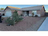 Charming single-story home featuring desert landscaping and a classic tile roof at 213 Beaver Ridge Ave, North Las Vegas, NV 89031