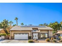 Charming single-story home with a two car garage, desert landscaping, and solar panels on the roof at 2233 Marlboro Dr, Henderson, NV 89014