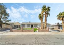 Charming single-story home with a well-manicured lawn and palm trees at 436 Bell Ave, Henderson, NV 89015