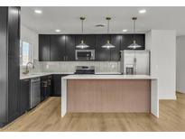 Modern kitchen with black cabinets, stainless steel appliances, and a stylish island at 4578 Ridgedale Ave, Las Vegas, NV 89121