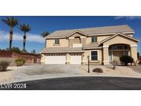 Two-story home with a three-car garage and desert landscaping under a clear blue sky at 4798 Luna Ridge Ct, Las Vegas, NV 89129