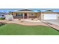 Charming single-story home with manicured lawn, brick accents, and a two-car garage at 524 8Th St, Boulder City, NV 89005