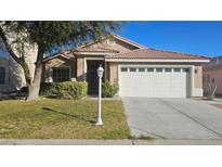 Charming single-story home featuring a well-manicured lawn and a two-car garage at 6028 Turtle River Ave, Las Vegas, NV 89156