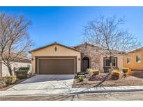 Charming single-story home with a two-car garage, stone accents, and drought-resistant landscaping at 7315 Summer Air Ave, Las Vegas, NV 89179