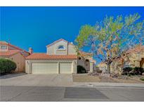 Charming two-story home featuring a terracotta tile roof and a spacious two-car garage at 8231 Wildfire St, Las Vegas, NV 89123