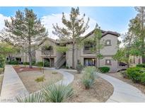 Inviting condominium with mature trees, desert landscaping and exterior stair access to upper units at 8250 N Grand Canyon Dr # 2059, Las Vegas, NV 89166