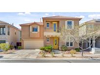 Charming two-story home with a yellow front door and a balcony over the entry at 9413 Ironsend St, Las Vegas, NV 89143