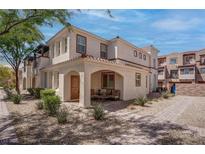 Charming townhome with stucco exterior, covered porch, and manicured landscaping in a desirable community at 1040 Via Panfilo Ave, Henderson, NV 89011