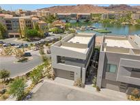 Modern exterior with a lake view featuring stucco siding and a two-car garage at 14 Heron Harbour Dr, Henderson, NV 89011