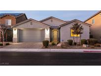 Charming single-story home featuring a two-car garage and an ornate metal security door at 1544 Karst Pond Ave, North Las Vegas, NV 89084