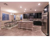 Spacious eat-in kitchen with large island, stainless steel appliances, and modern cabinetry at 1544 Karst Pond Ave, North Las Vegas, NV 89084