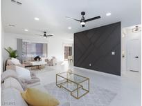 Bright and airy living room featuring contemporary furnishings and stylish decor at 2125 Desert Woods Dr, Henderson, NV 89012