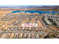 Spectacular aerial view of a lakefront community with modern homes and scenic mountain backdrop at 24 Cliffwater St, Henderson, NV 89011