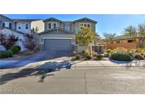 Charming two-story home with a well-manicured lawn and inviting curb appeal on a sunny day at 2832 Aragon Terrace Way, Henderson, NV 89044