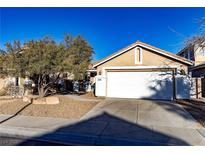 Charming single-story home features a two-car garage, desert landscaping, and a cozy, inviting entrance at 3208 Paragon Pointe St, Las Vegas, NV 89129