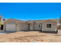 Charming single story home with a two car garage and desert landscaping at 395 W Cox Ave, Overton, NV 89040