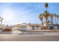 Charming single story home with a two car garage and well maintained front yard at 5399 Surrey St, Las Vegas, NV 89119