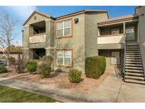 Well-maintained two-story condo building with private balconies and landscaped grounds at 555 E Silverado Ranch Blvd # 2033, Las Vegas, NV 89183