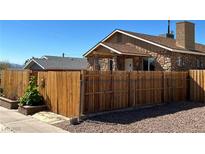 Charming home with a stone exterior, wooden fence and front yard landscaping at 628 Avenue L, Boulder City, NV 89005